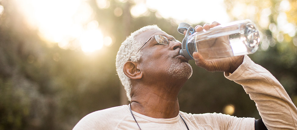drinking-water-outside-891167436.jpg Man drinking water outside