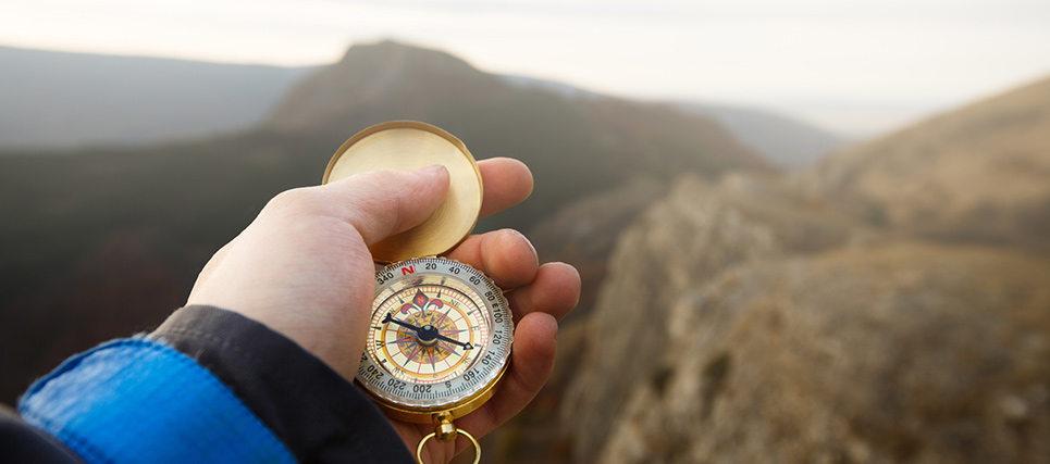 holding-a-compass-837335608.jpg Person Holding a Compass