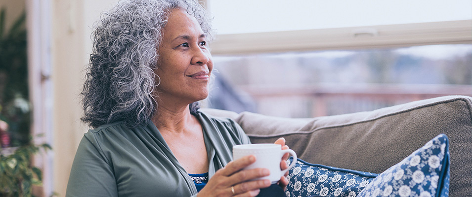 woman having coffee and looking outside